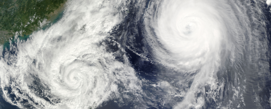 Photo of two hurricanes forming over an ocean